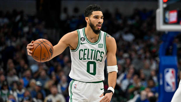 Celtics forward Jayson Tatum dribbles against the Mavericks defense.